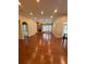 Large living room with hardwood floors, stone fireplace, and an abundance of natural light at 430 La Perla Dr, Sugar Hill, GA 30518