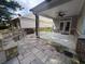 Covered patio has stone flooring, custom stone benches, ceiling fan, and access to the back yard at 430 La Perla Dr, Sugar Hill, GA 30518