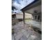 Covered patio has stone flooring, custom stone benches, ceiling fan, and access to the back yard at 430 La Perla Dr, Sugar Hill, GA 30518