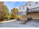 Backyard view with a private deck, garage, and lush foliage with fall colors at 5667 Cascade Sw Run, Atlanta, GA 30336