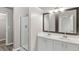 Dual sink bathroom with framed mirrors and a glass shower at 5667 Cascade Sw Run, Atlanta, GA 30336