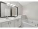 Double vanity bathroom with framed mirrors and a soaking tub at 5667 Cascade Sw Run, Atlanta, GA 30336
