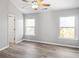 Bedroom with vaulted ceiling, ceiling fan, and windows overlooking trees at 5667 Cascade Sw Run, Atlanta, GA 30336