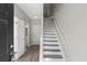 Bright entryway with hardwood floors and staircase, leading to upper levels at 5667 Cascade Sw Run, Atlanta, GA 30336