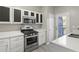 Updated kitchen with stainless steel stove and a door leading to an outdoor patio or balcony at 5667 Cascade Sw Run, Atlanta, GA 30336