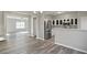 Modern kitchen with stainless steel appliances and sleek white cabinets, open to the dining and living area at 5667 Cascade Sw Run, Atlanta, GA 30336