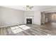 Inviting living room boasts a fireplace, neutral paint, and wood-look floors at 5667 Cascade Sw Run, Atlanta, GA 30336