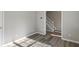 Neutral room with hardwood floors offers view of entryway and staircase at 5667 Cascade Sw Run, Atlanta, GA 30336
