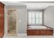 Bright bathroom features a soaking tub with tile surround and a glass-enclosed shower at 2291 Falmouth Se Ct # 23, Smyrna, GA 30080
