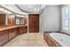 Luxury bathroom with a soaking tub, wood cabinets, and tile flooring at 2291 Falmouth Se Ct # 23, Smyrna, GA 30080