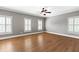 Large bedroom with hardwood floors and multiple windows, offering plenty of natural light at 2291 Falmouth Se Ct # 23, Smyrna, GA 30080