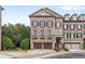 Beautiful brick townhome featuring a two-car garage, black shutters, and manicured landscaping at 2291 Falmouth Se Ct # 23, Smyrna, GA 30080