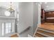 Grand foyer featuring hardwood floors, a chandelier, and views into the kitchen at 2291 Falmouth Se Ct # 23, Smyrna, GA 30080