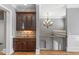Elegant hallway with a wet bar, chandelier, and staircase at 2291 Falmouth Se Ct # 23, Smyrna, GA 30080