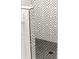 This bathroom shower has a black and white accent tiled wall and floor with drain at 2327 Mason Dr # D23, Atlanta, GA 30316