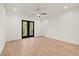 Spacious bedroom with hardwood floors, a ceiling fan, and double doors that lead to a balcony at 2327 Mason Dr # D23, Atlanta, GA 30316
