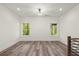 Spacious bedroom with two windows and dark laminate flooring at 2327 Mason Dr # D23, Atlanta, GA 30316