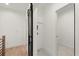 Hallway features a modern barn door, adjacent laundry area and neutral colored carpet and paint at 2327 Mason Dr # D23, Atlanta, GA 30316