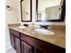 Bathroom featuring a double vanity with dark cabinets, granite countertops, and modern faucets at 958 Nevis Way, Mcdonough, GA 30253