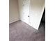 Cozy bedroom with neutral carpet and a white door, creating a serene and comfortable space at 958 Nevis Way, Mcdonough, GA 30253