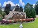 Annaberg community entrance featuring a beautiful brick sign and manicured flower beds and greenery at 958 Nevis Way, Mcdonough, GA 30253