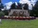 Annaberg community entrance featuring a beautiful brick sign and manicured flower beds and greenery at 958 Nevis Way, Mcdonough, GA 30253