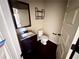 Cozy half-bathroom featuring stylish fixtures, a vanity with storage, and a mirror, maximizing the space at 958 Nevis Way, Mcdonough, GA 30253
