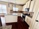 Bright kitchen features a center island, stainless steel appliances, granite countertops and plenty of cabinet space at 958 Nevis Way, Mcdonough, GA 30253
