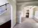 Inviting living room showcasing an open floor plan, with archways and views to the kitchen, and staircase at 958 Nevis Way, Mcdonough, GA 30253
