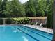 Community pool at Annaberg features multiple chairs for lounging and space for relaxing at 958 Nevis Way, Mcdonough, GA 30253