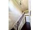 Elegant staircase featuring iron spindles, wood railing, and decorative wainscoting adding charm to this residence at 958 Nevis Way, Mcdonough, GA 30253