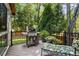 Outdoor back deck with built-in grill, seating, and privacy overlooking a lush, green yard at 1835 Redbourne Dr, Atlanta, GA 30350