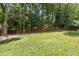 Lush backyard with a green lawn and mature trees, offering privacy and space for outdoor activities at 1835 Redbourne Dr, Atlanta, GA 30350