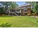 Expansive backyard with a screened porch, deck, and well-maintained lawn at 1835 Redbourne Dr, Atlanta, GA 30350