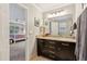 Dark wood vanity and granite countertop bathroom featuring a connected bedroom view and lots of natural light at 1835 Redbourne Dr, Atlanta, GA 30350
