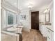 Bright bathroom featuring a soaking tub with window shutters and a vanity with dark wood cabinets at 1835 Redbourne Dr, Atlanta, GA 30350