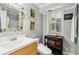 Bright bathroom with updated vanity, mosaic mirror, and unique fixtures at 1835 Redbourne Dr, Atlanta, GA 30350