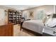 This bedroom features a decorative bookshelf, wood furniture, and natural light streaming through shuttered windows at 1835 Redbourne Dr, Atlanta, GA 30350