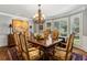 Formal dining room with wainscoting, chandelier, and large windows with wooden shutters at 1835 Redbourne Dr, Atlanta, GA 30350