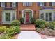 Covered front entrance featuring brick steps, arched entry, and sidelight windows at 1835 Redbourne Dr, Atlanta, GA 30350