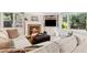 Cozy living room featuring a brick fireplace, built-in shelves, and large windows with natural light at 1835 Redbourne Dr, Atlanta, GA 30350