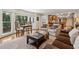 Bright living area with large windows, wood floors, and seamless flow to the kitchen at 1835 Redbourne Dr, Atlanta, GA 30350