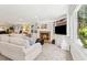 Spacious living room with a fireplace, built-in shelves, and large windows overlooking the backyard at 1835 Redbourne Dr, Atlanta, GA 30350