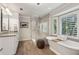 Bright main bathroom featuring a soaking tub, glass shower, and double sink vanity at 1835 Redbourne Dr, Atlanta, GA 30350