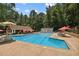 Bright community pool with covered seating, lounge chairs, and umbrellas at 1835 Redbourne Dr, Atlanta, GA 30350