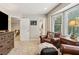 Cozy sitting room with a wall mounted tv, plush armchairs, and large windows offering lots of natural light at 1835 Redbourne Dr, Atlanta, GA 30350