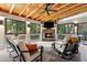 Inviting sunroom boasts a stone fireplace, wood ceiling, and ample seating for year-round enjoyment at 1835 Redbourne Dr, Atlanta, GA 30350