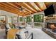 Bright sunroom featuring a stone fireplace, wood ceiling, and large windows for natural light and views at 1835 Redbourne Dr, Atlanta, GA 30350