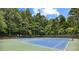 Outdoor tennis courts surrounded by a canopy of lush green trees at 1835 Redbourne Dr, Atlanta, GA 30350