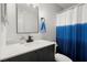 Modern bathroom features a sleek vanity and blue and white shower curtain at 301 Parkaire Xing, Marietta, GA 30068